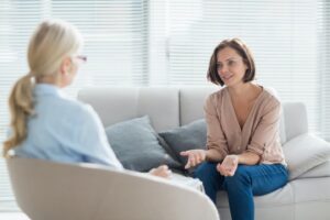 A woman engaging in a virtual therapy session